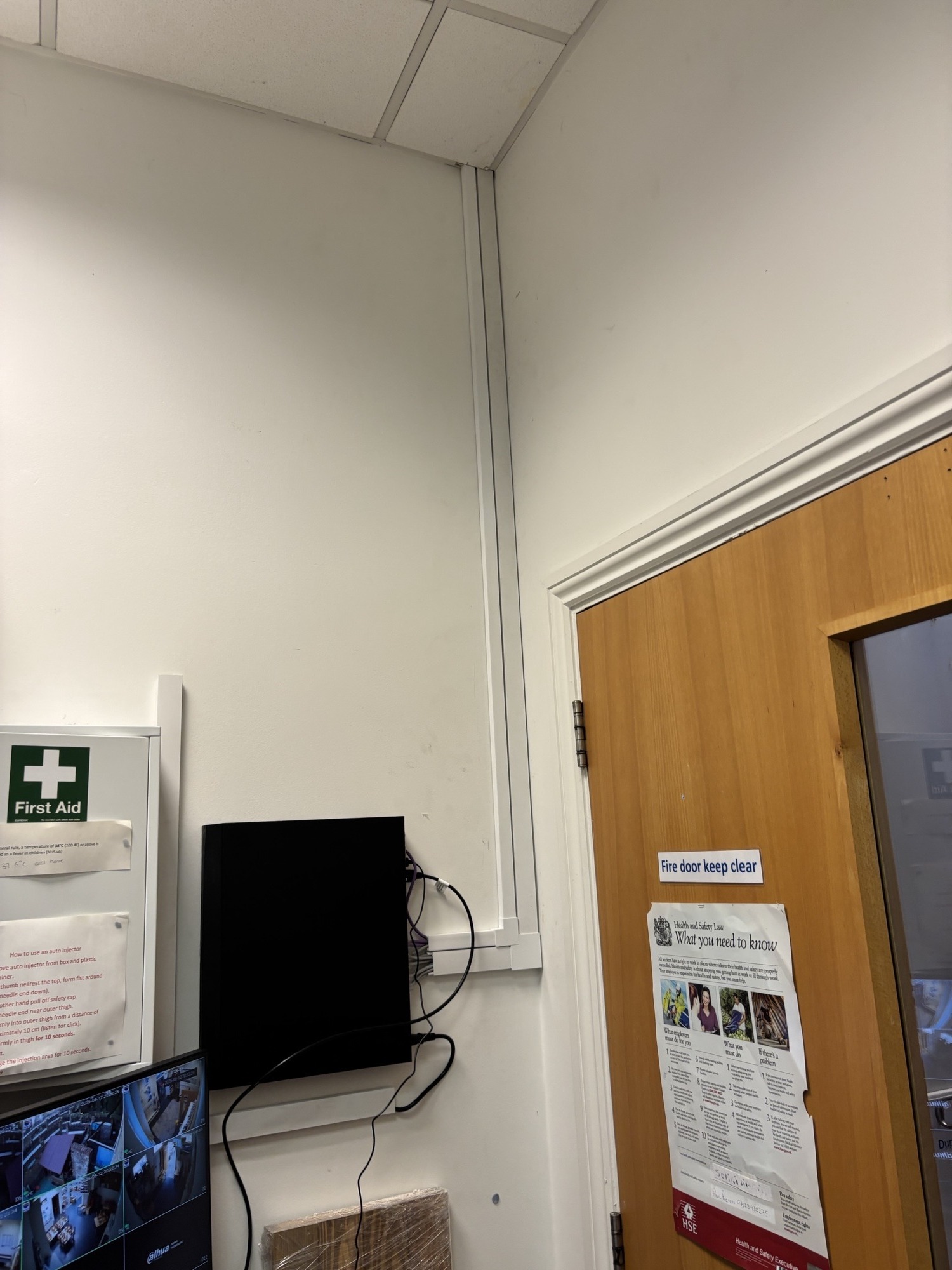CCTV camera installed on a building exterior near a window